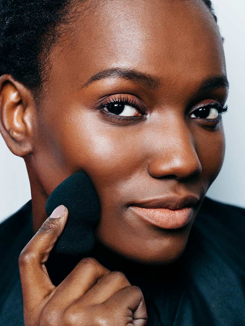Festival Flare model applying Fit Me Foundation on cheek