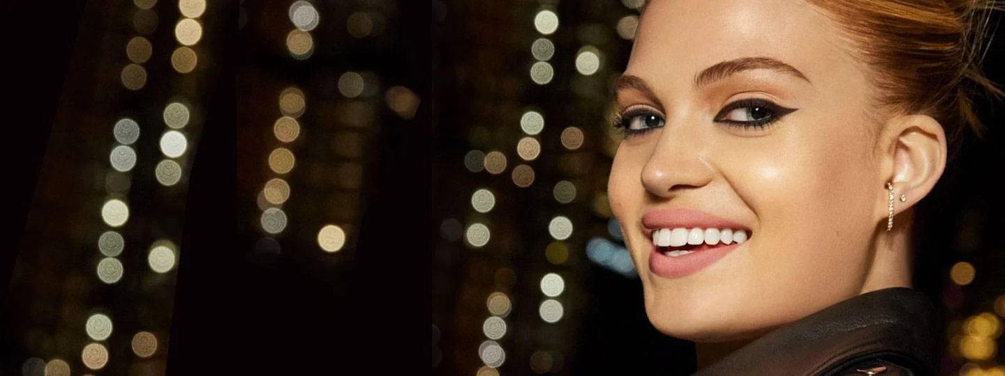 Woman smiling - city lights in the background